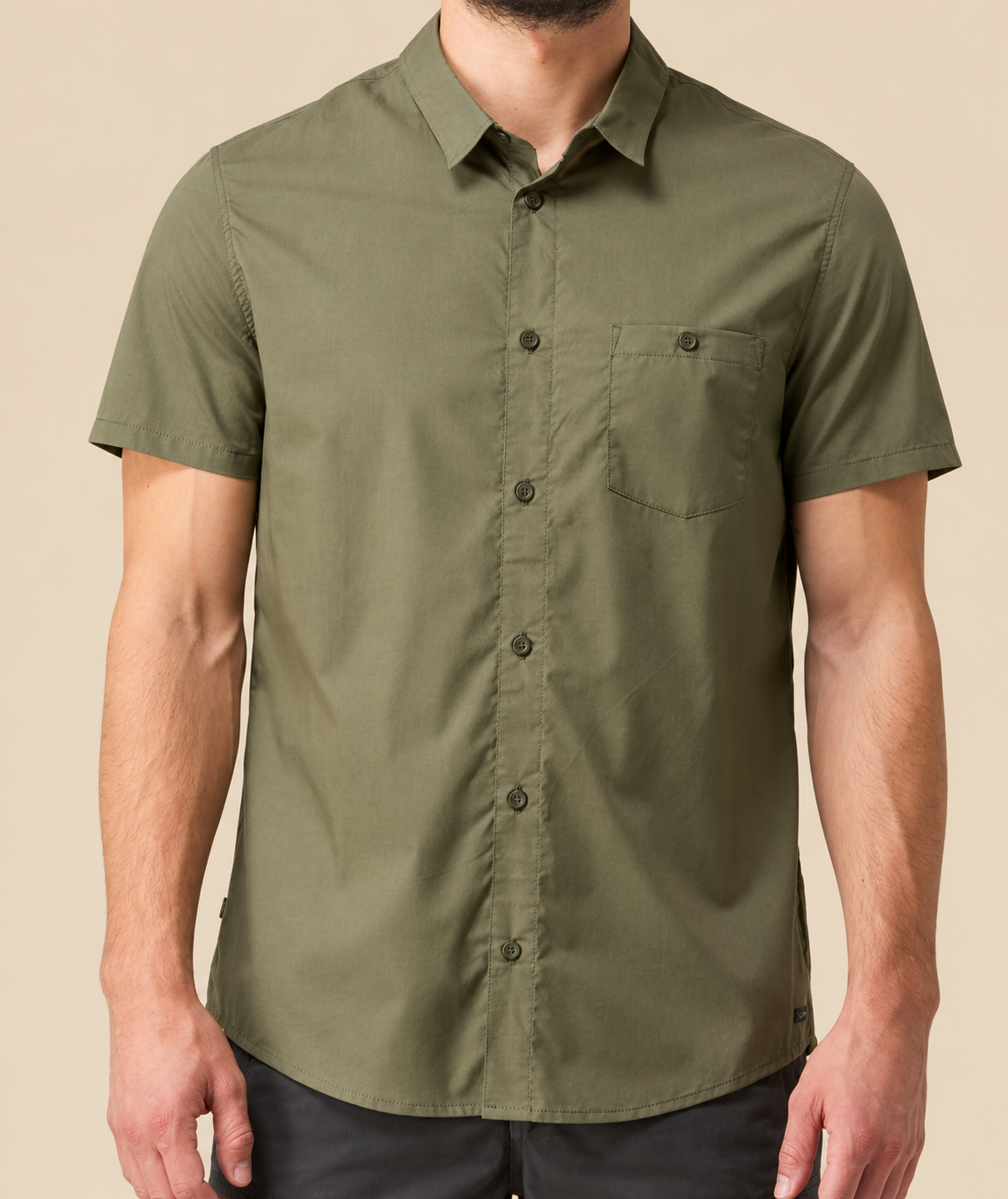 Model wearing an olive short-sleeve utility shirt with a chest pocket