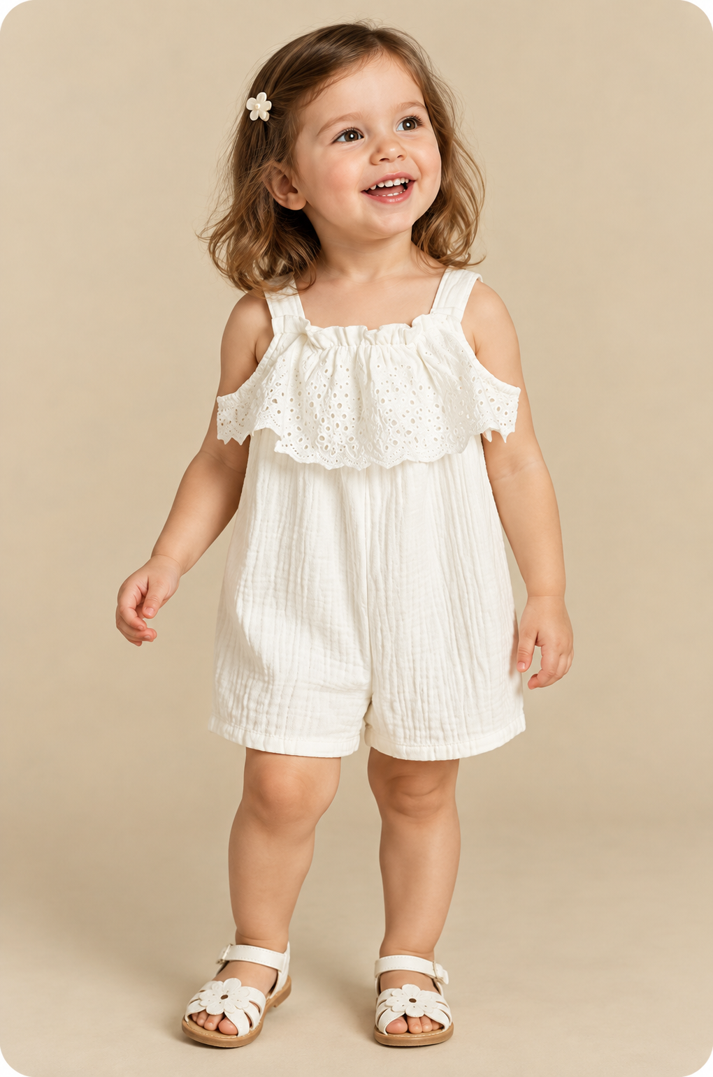 Toddler wearing an off-white eyelet lace romper with ruffle trim