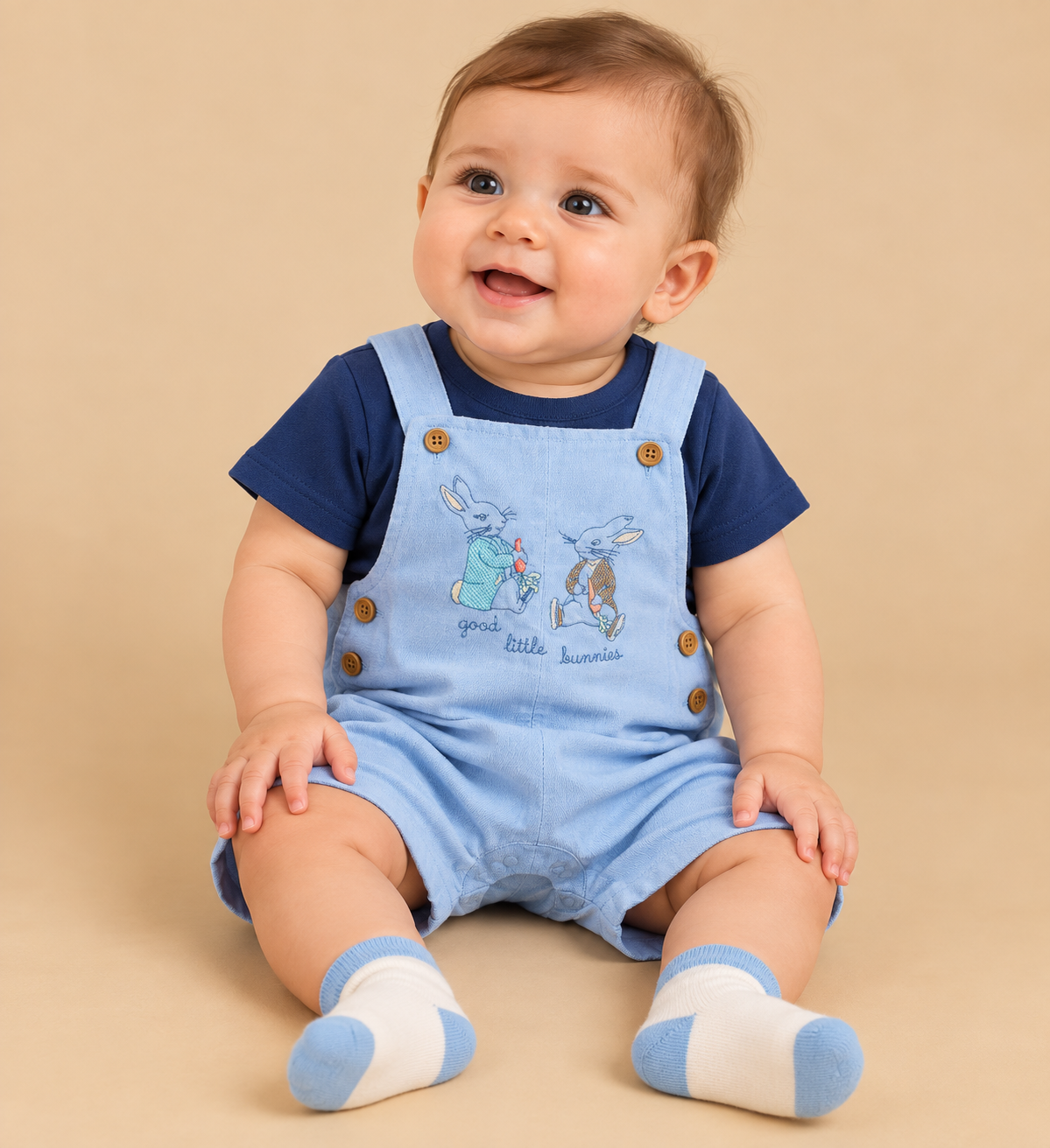 Baby wearing bunny-embroidered cotton overalls