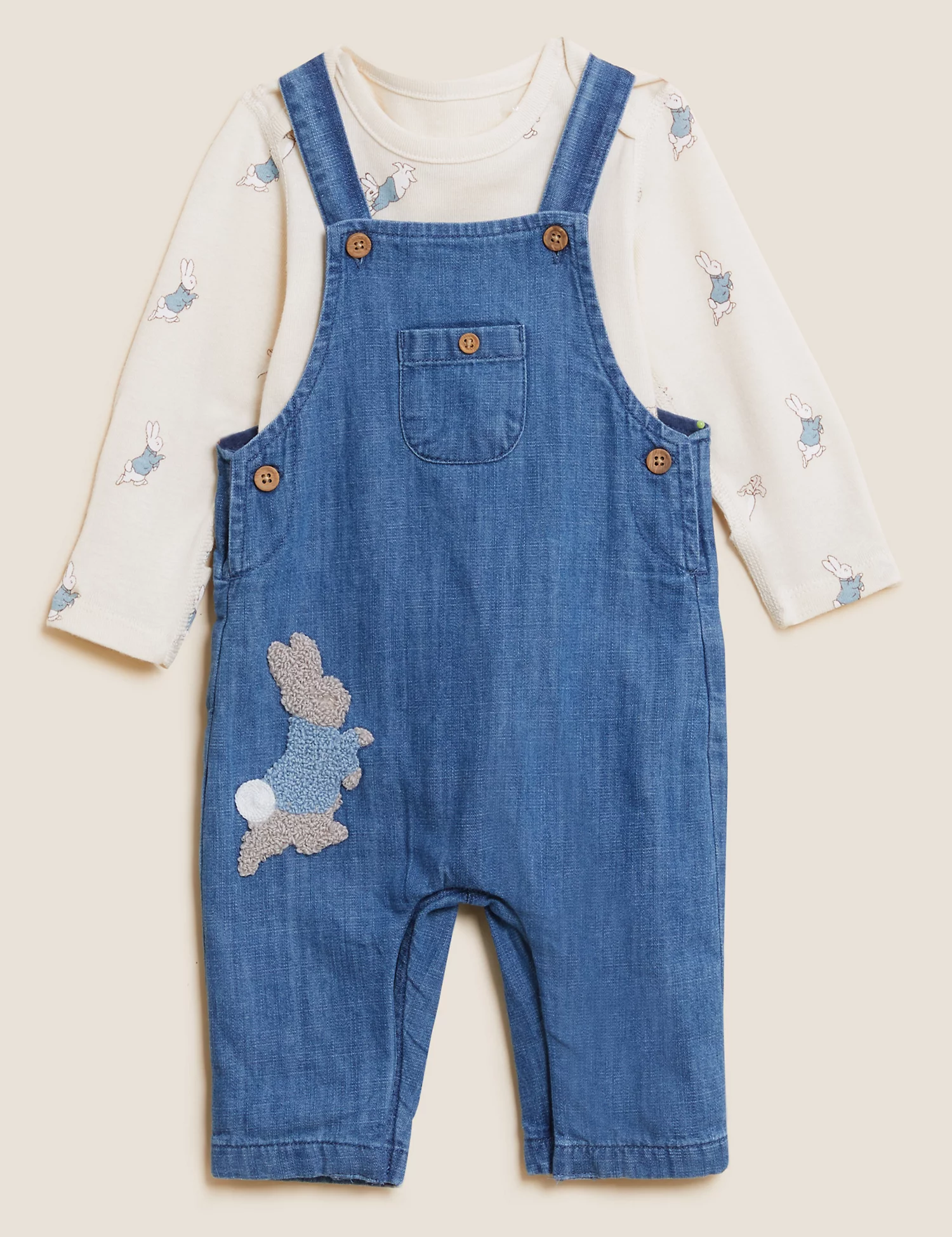 Flat lay of blue chambray dungarees with a rabbit-print long-sleeve top